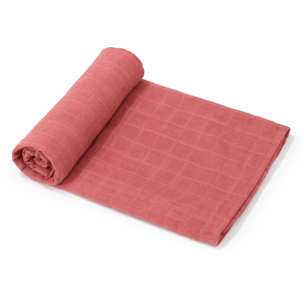 rust maroon organic bamboo + cotton muslin baby swaddle blanket rolled on white background