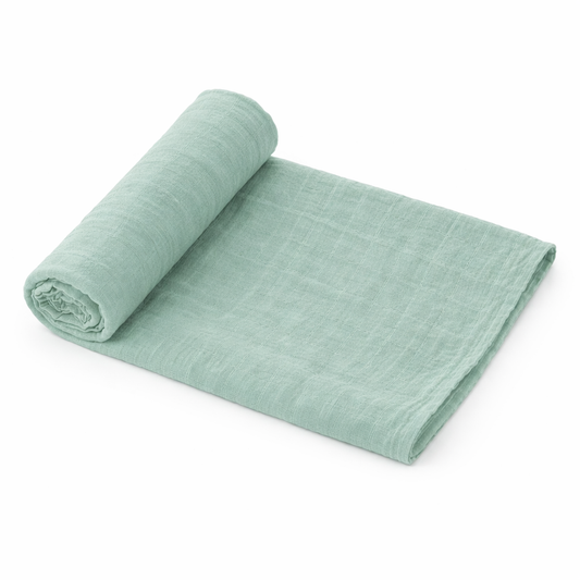 Green organic muslin baby swaddle blanket rolled on white background