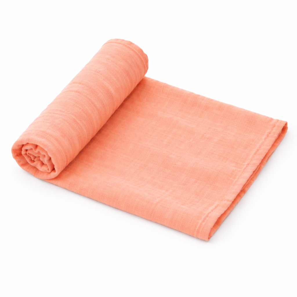 Coral organic muslin baby swaddle blanket rolled on white background